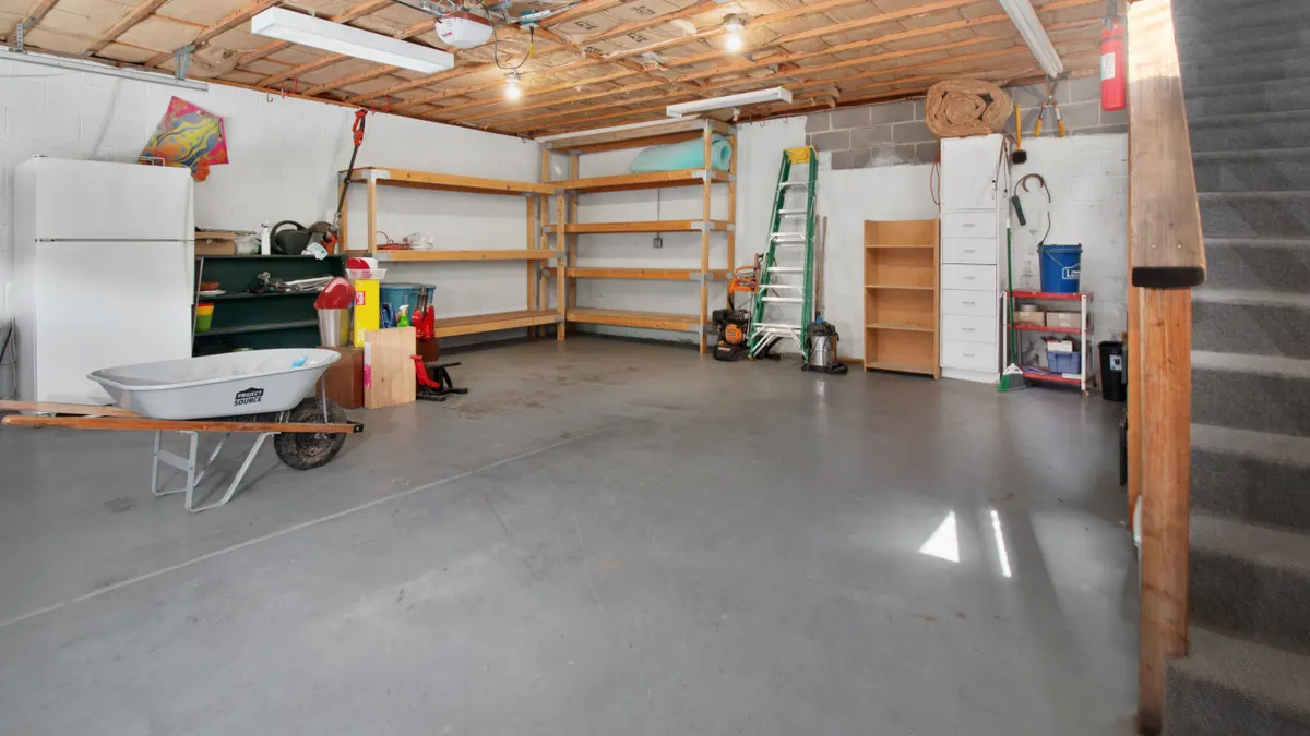 Can Interior Concrete Floors Be Levelled From the Outside? unfinished basement garage with concrete floor and storage
