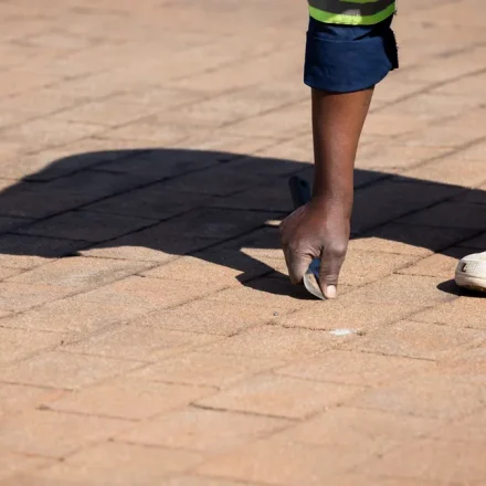 Worker inspecting a paved driveway surface