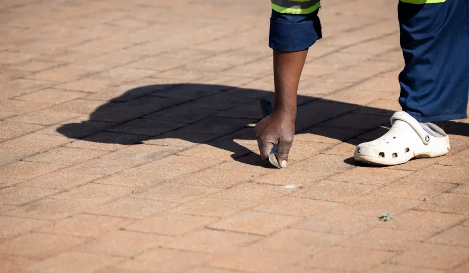 Worker inspecting a paved driveway surface