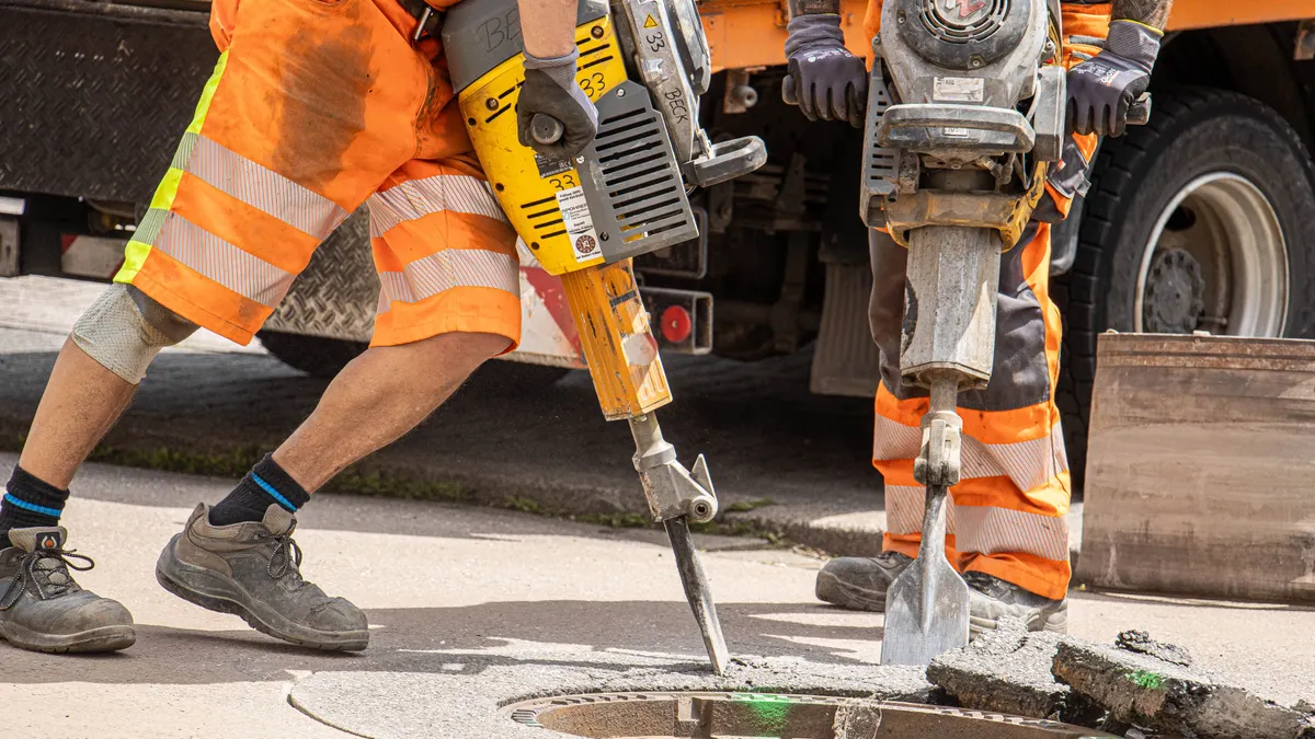 Do New York Building Types Create Different Slab Repair Challenges? Workers jackhammering a concrete street opening