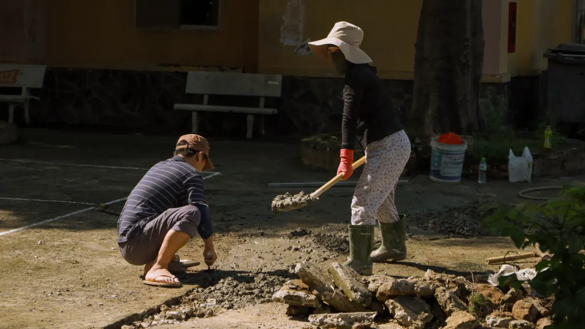 Do New York Building Types Create Different Slab Repair Challenges? Two people breaking up concrete with sledgehammers